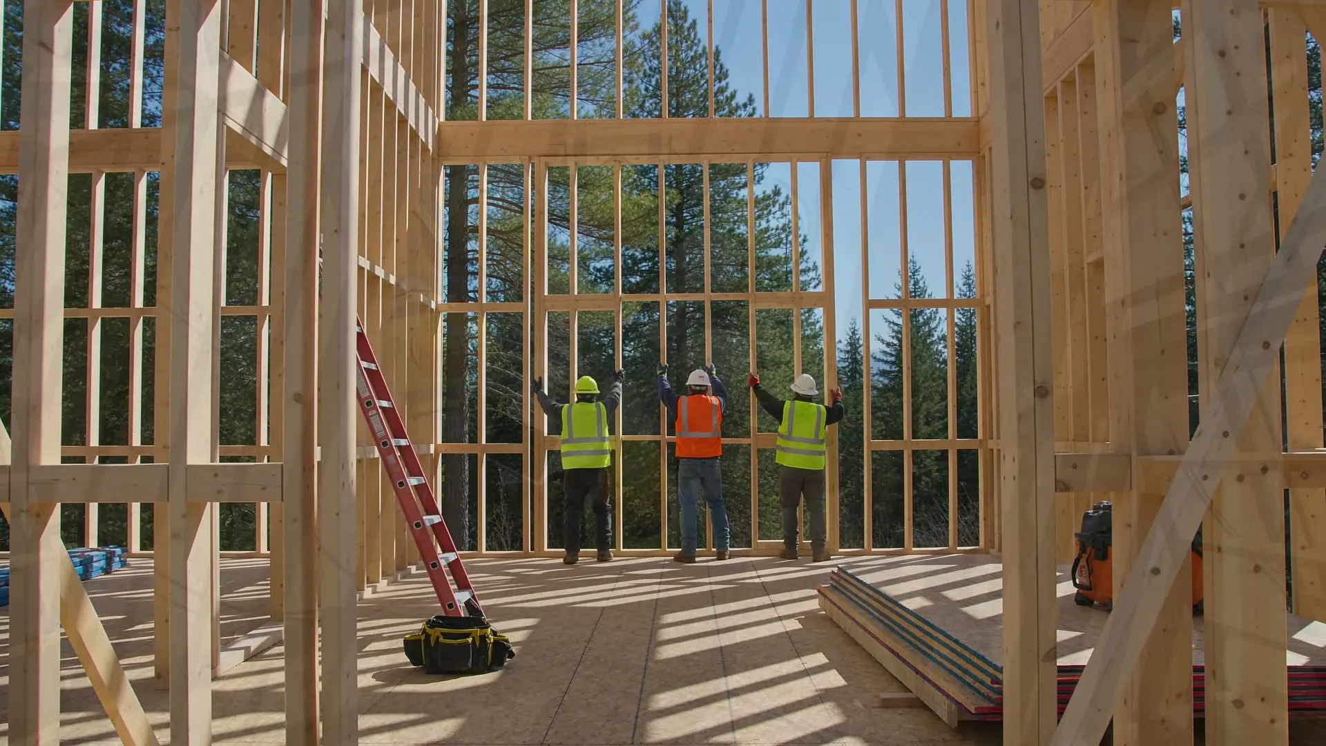 Crew raising a framed timber wall on a commercial jobsite